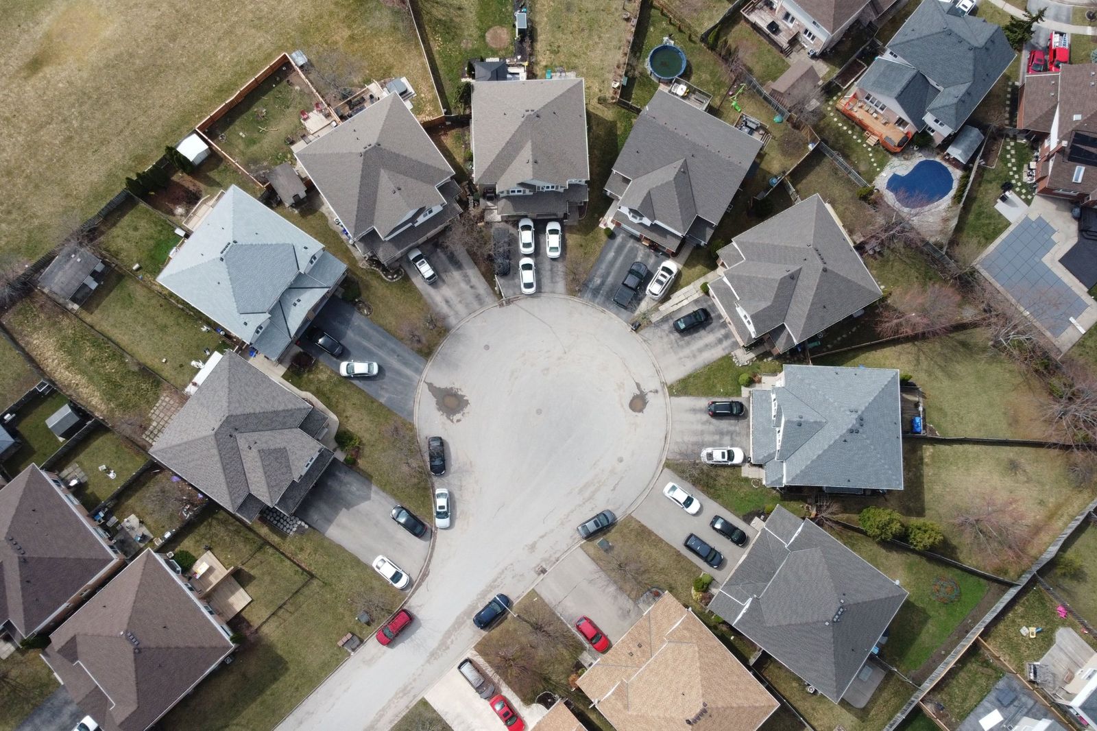 Aerial view of homes with cars in their driveways